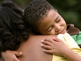 Son cuddling his mother affectionately